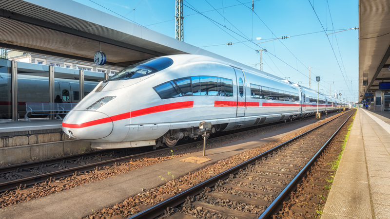 Infrastruktur: Zug auf Schienen an einem Bahnhof