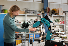 Arbeiter neben Roboterarm